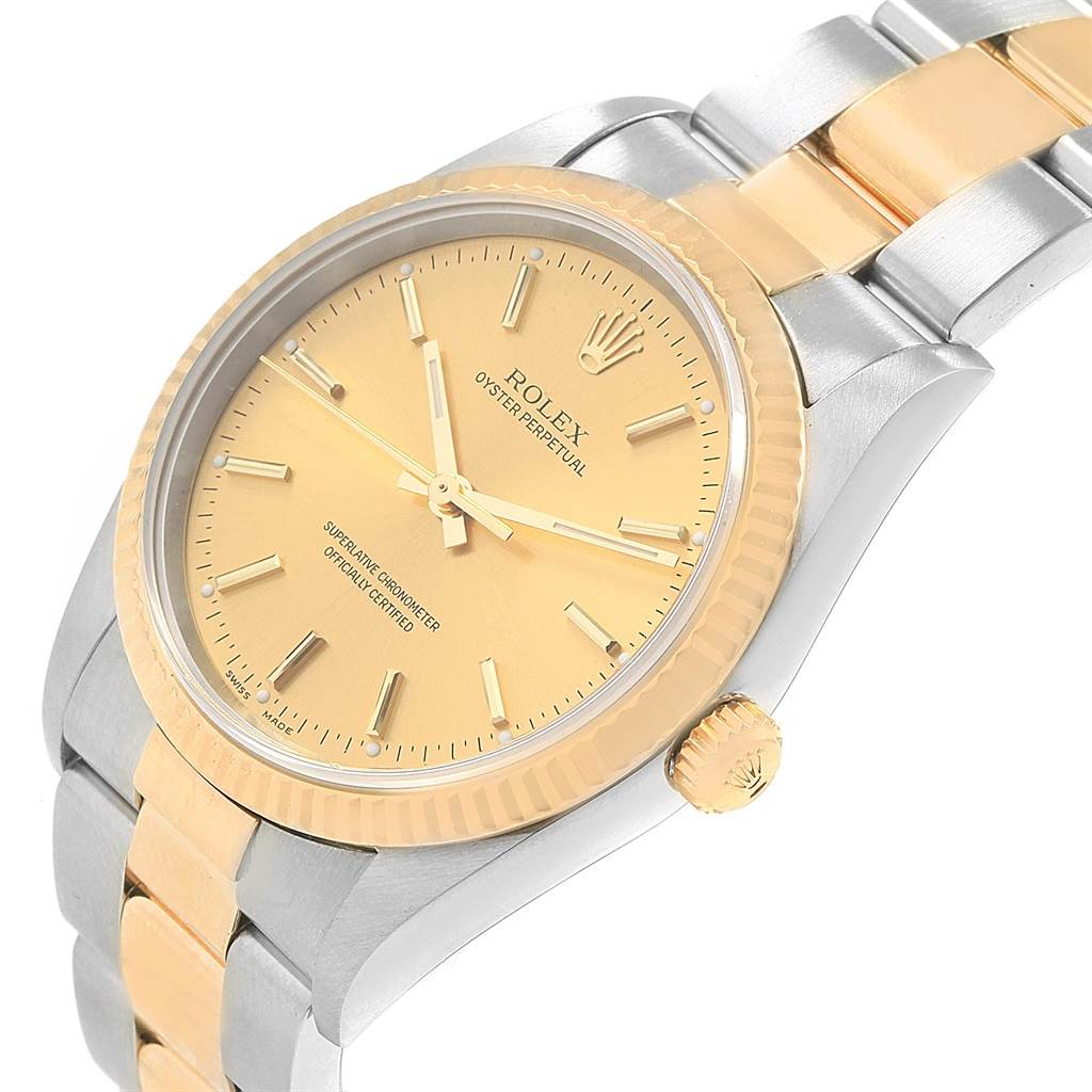 The image shows a side-angle view of the Rolex Oyster Perpetual 14233 Men's Steel and Gold (two tone) Champagne Dial 14233 Men's Steel and Gold (two tone) Champagne Dial, revealing its gold bezel, dial, and two-tone bracelet.