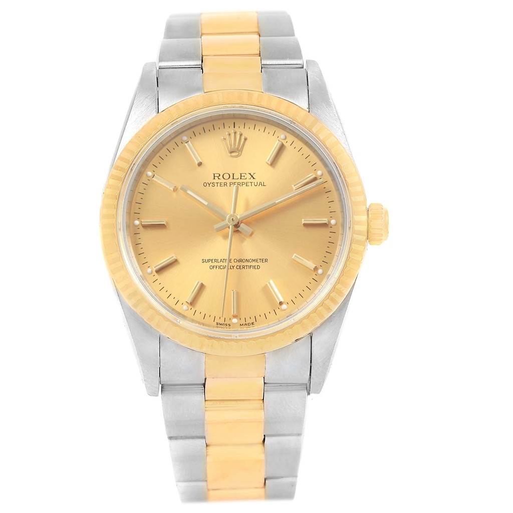 The image shows a frontal view of a Rolex Oyster Perpetual 14233 Men's Steel and Gold (two tone) Champagne Dial 14233 Men's Steel and Gold (two tone) Champagne Dial watch, highlighting its gold dial, bezel, and two-tone metal bracelet.