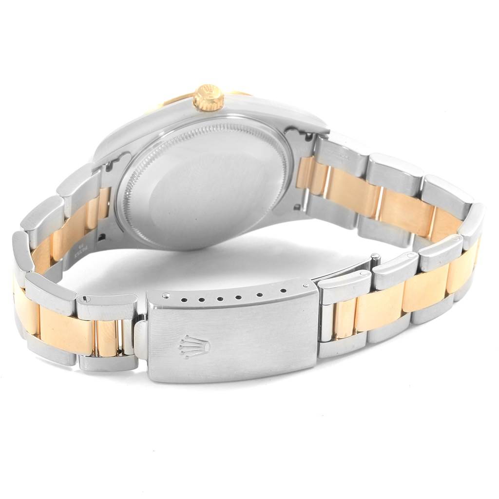 The image shows the back of the Rolex Oyster Perpetual 14233 Men's Steel and Gold (two tone) Champagne Dial 14233 Men's Steel and Gold (two tone) Champagne Dial watch, highlighting the case back, crown, and two-tone bracelet.