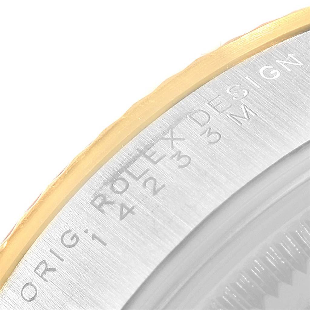 This image shows a close-up of the side of the bezel and case back of a Rolex Oyster Perpetual 14233 Men's Steel and Gold (two tone) Champagne Dial 14233 Men's Steel and Gold (two tone) Champagne Dial watch.