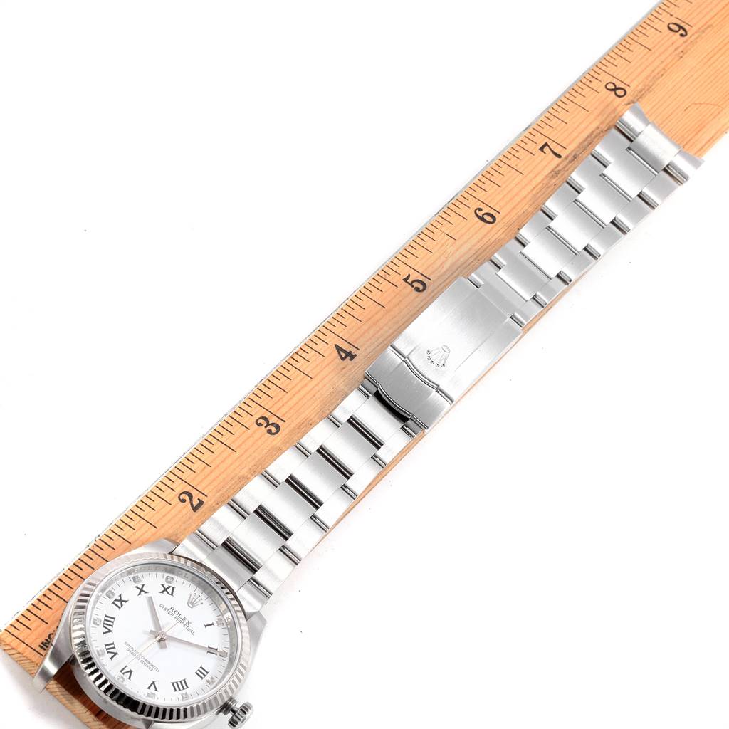 The image shows a Rolex Oyster Perpetual 116034 Men's Stainless Steel White Dial 116034 Men's Stainless Steel White Dial watch laid flat with a ruler for scale, displaying the face, bracelet, and clasp.