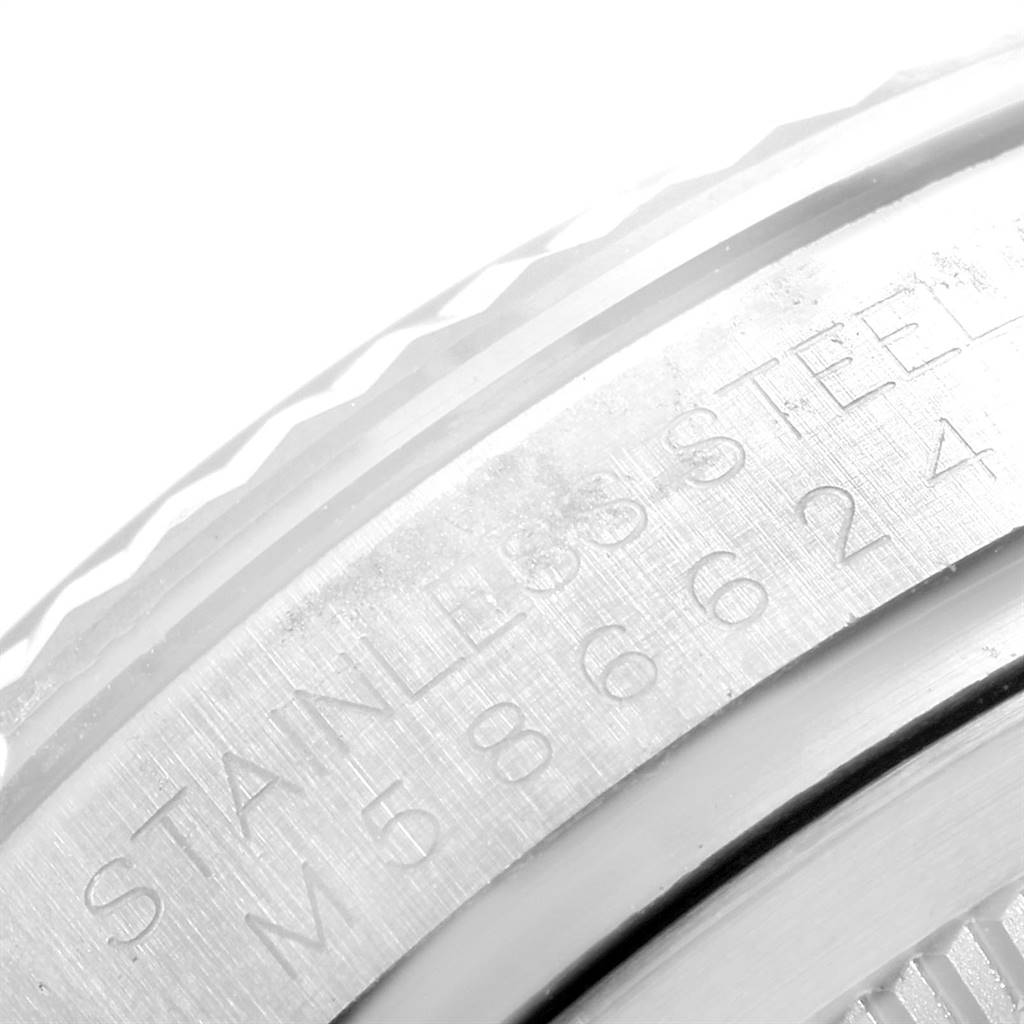 This is a close-up of the engraved edge and bezel of a Rolex Oyster Perpetual 116034 Men's Stainless Steel White Dial 116034 Men's Stainless Steel White Dial watch.