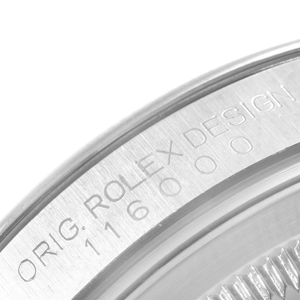 This image shows a close-up of the engraved case back of the Rolex Oyster Perpetual 116000 Men
s Stainless Steel Black Dial 116000 Men
s Stainless Steel Black Dial watch.