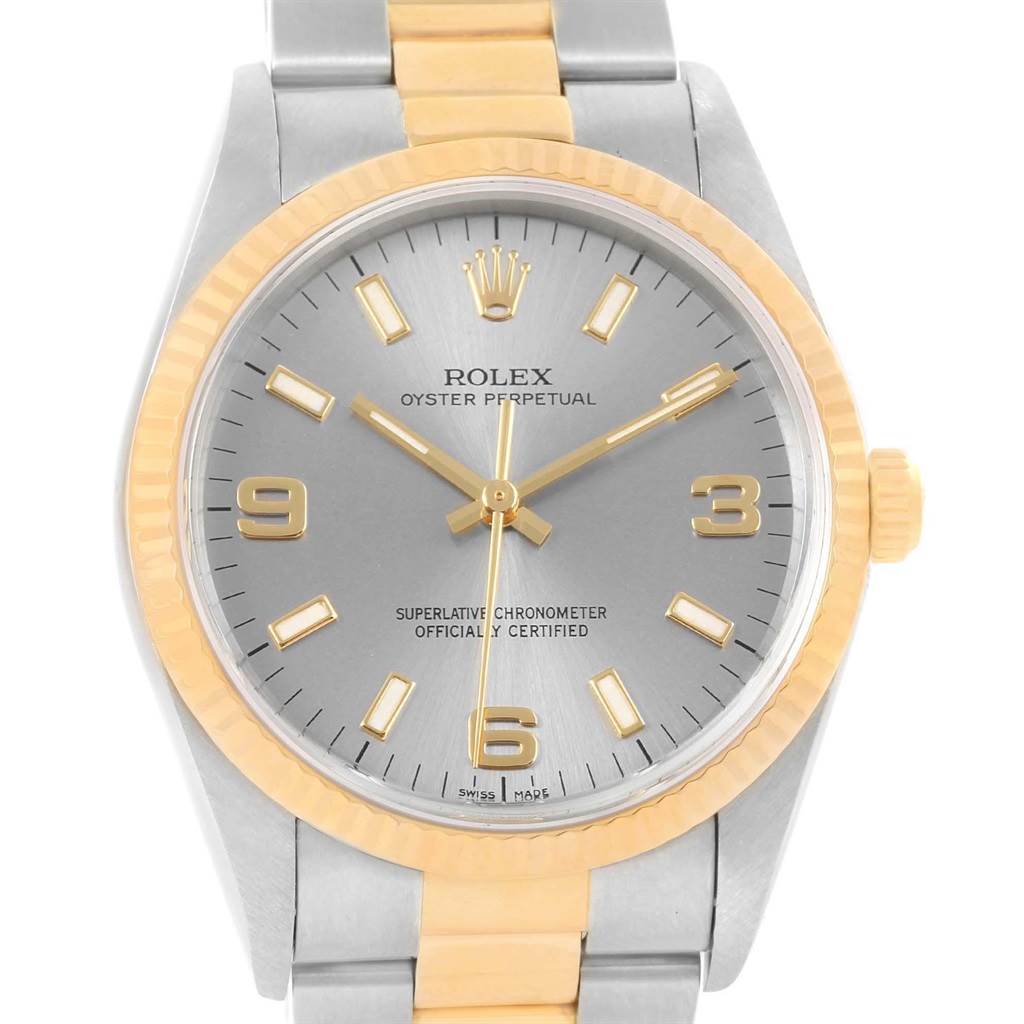 The image shows a frontal view of a Rolex Oyster Perpetual 14233 Men
s Steel and Gold (two tone) Grey Dial 14233 Men
s Steel and Gold (two tone) Grey Dial watch, highlighting the dial, bezel, and bracelet.