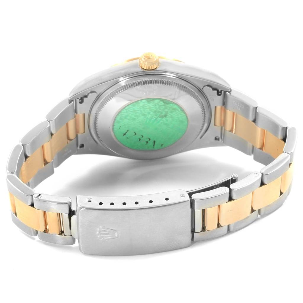 The image shows the back case, bracelet, and clasp of a Rolex Oyster Perpetual 14233 Men
s Steel and Gold (two tone) Grey Dial 14233 Men
s Steel and Gold (two tone) Grey Dial watch at an angle.