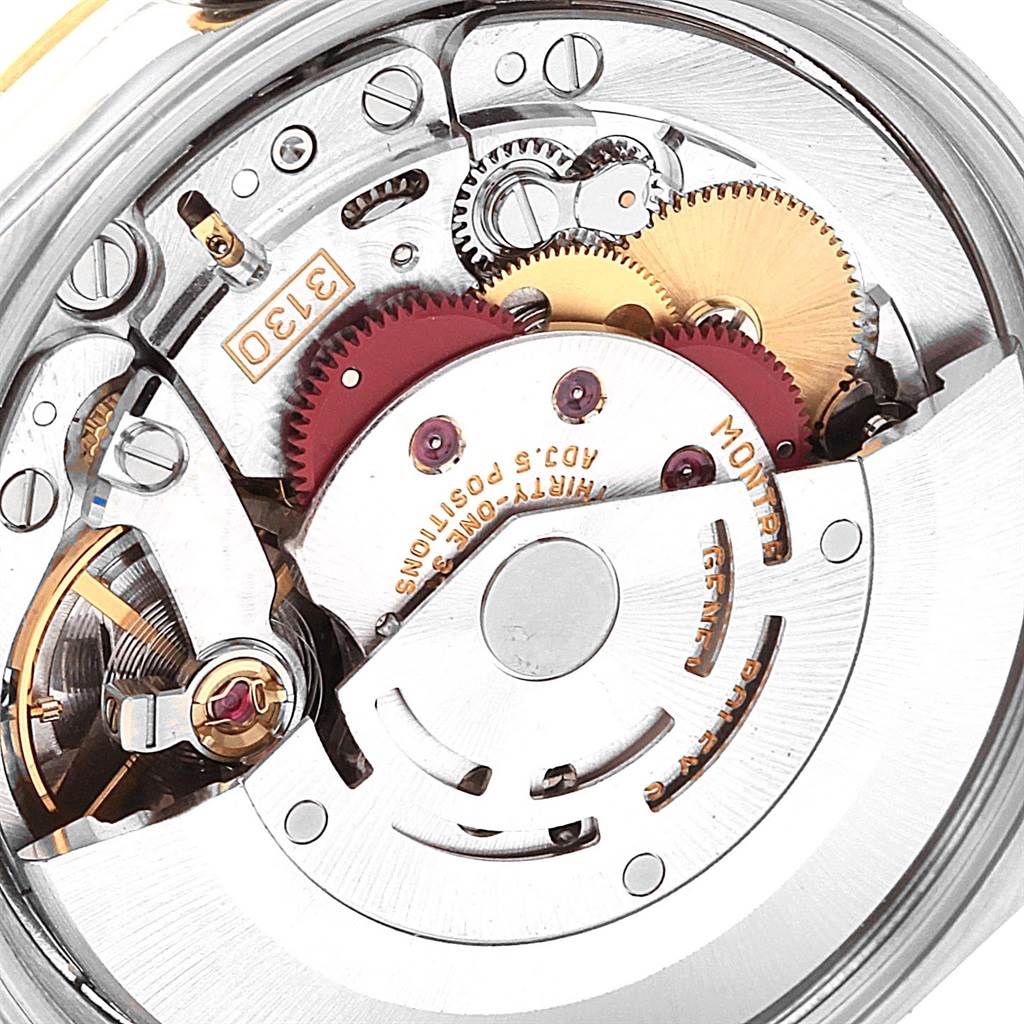 This is a close-up of the movement mechanism inside a Rolex Oyster Perpetual 14233 Men
s Steel and Gold (two tone) Grey Dial 14233 Men
s Steel and Gold (two tone) Grey Dial watch, showing gears and various intricate components.