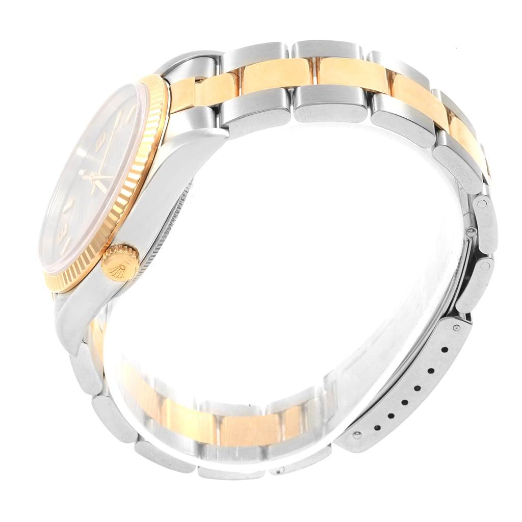 The image shows a side profile of a Rolex Oyster Perpetual 14233 Men
s Steel and Gold (two tone) Grey Dial 14233 Men
s Steel and Gold (two tone) Grey Dial watch, highlighting the two-tone bracelet and crown.