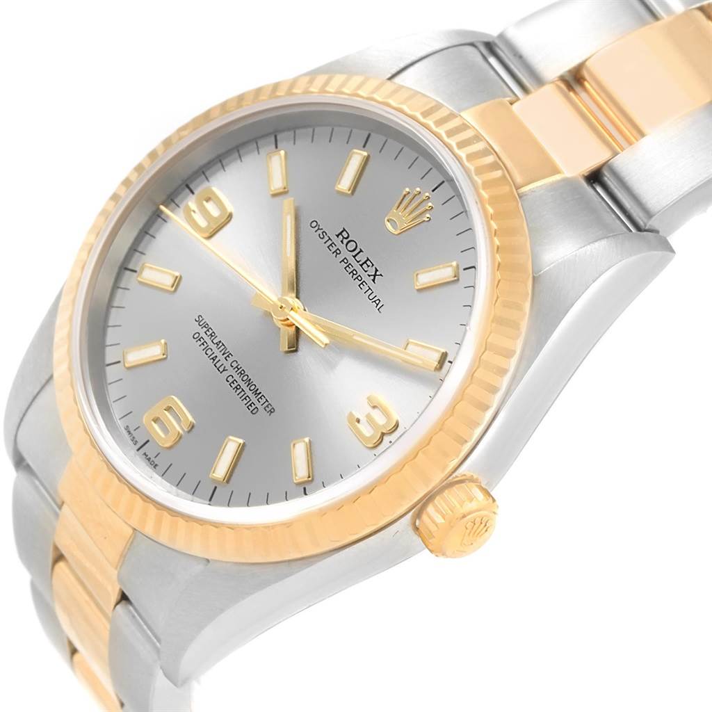 The image shows a close-up angle of the Rolex Oyster Perpetual 14233 Men
s Steel and Gold (two tone) Grey Dial 14233 Men
s Steel and Gold (two tone) Grey Dial watch, highlighting the dial, bezel, crown, and part of the bracelet.