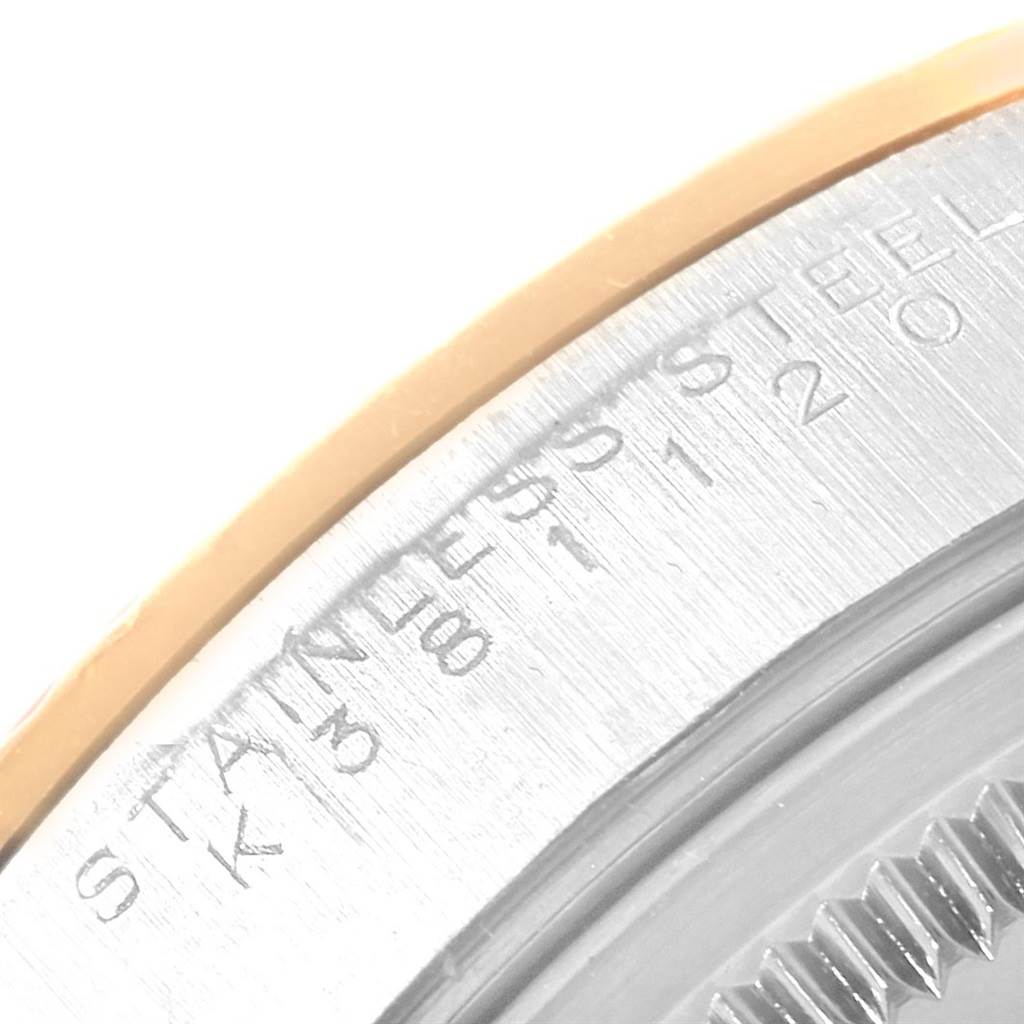 This image shows a close-up angle of the back casing and edge markings of a Rolex Oyster Perpetual 14233 Men's Steel and Gold (two tone) Blue Dial 14233 Men's Steel and Gold (two tone) Blue Dial watch.
