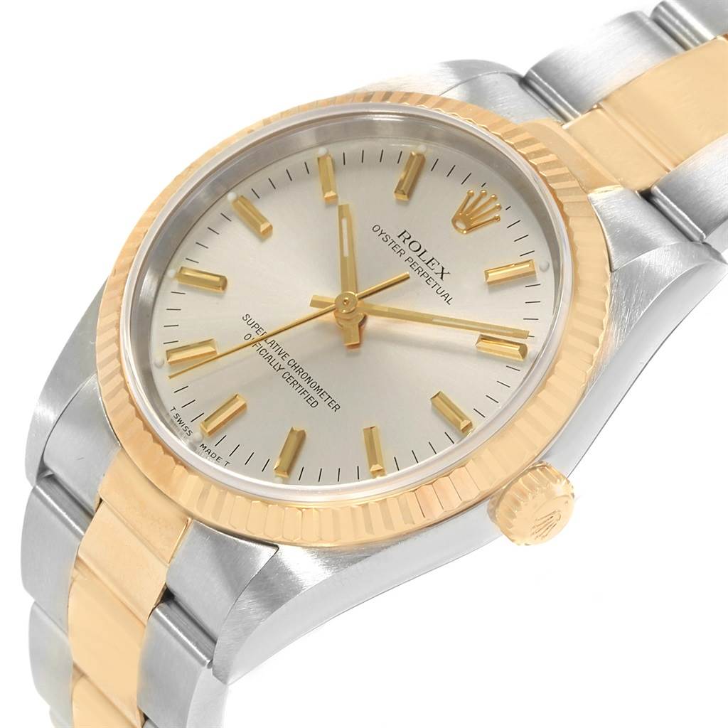 This image shows a close-up, angled view of the dial, bezel, and part of the bracelet of a Rolex Oyster Perpetual 14233 Men's Steel and Gold (two tone) Silver Dial 14233 Men's Steel and Gold (two tone) Silver Dial watch.