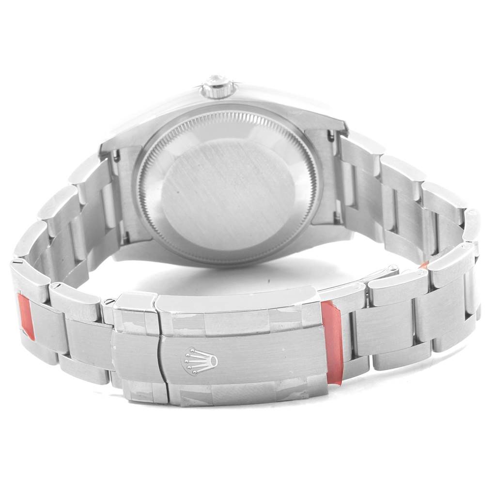 The image shows the back view of a Rolex Oyster Perpetual 114200 Men's Stainless Steel Silver Dial 114200 Men's Stainless Steel Silver Dial watch, highlighting its case back and clasp.