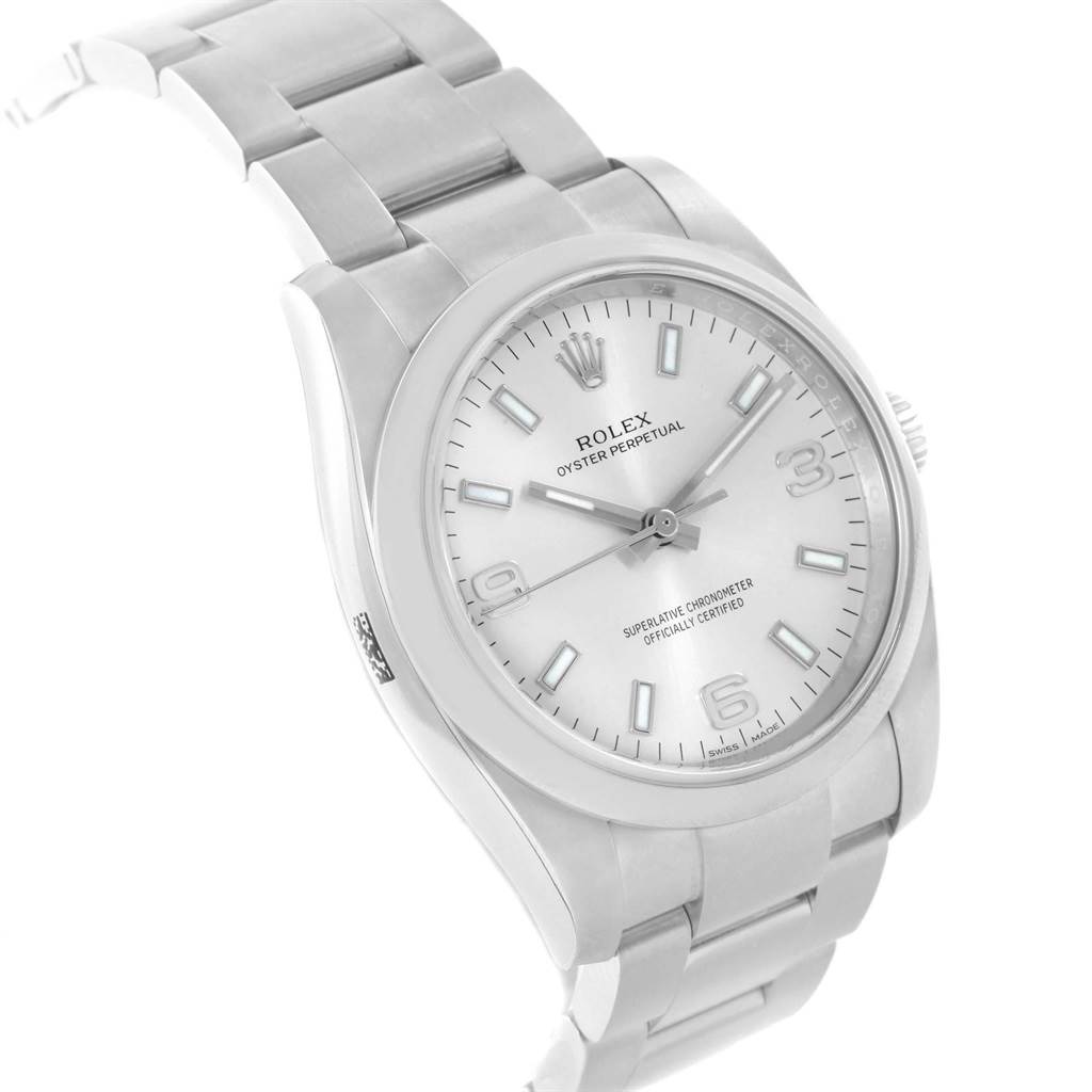 The Rolex Oyster Perpetual 114200 Men's Stainless Steel Silver Dial 114200 Men's Stainless Steel Silver Dial watch is shown at a three-quarter angle, displaying the dial, bezel, and part of the bracelet.