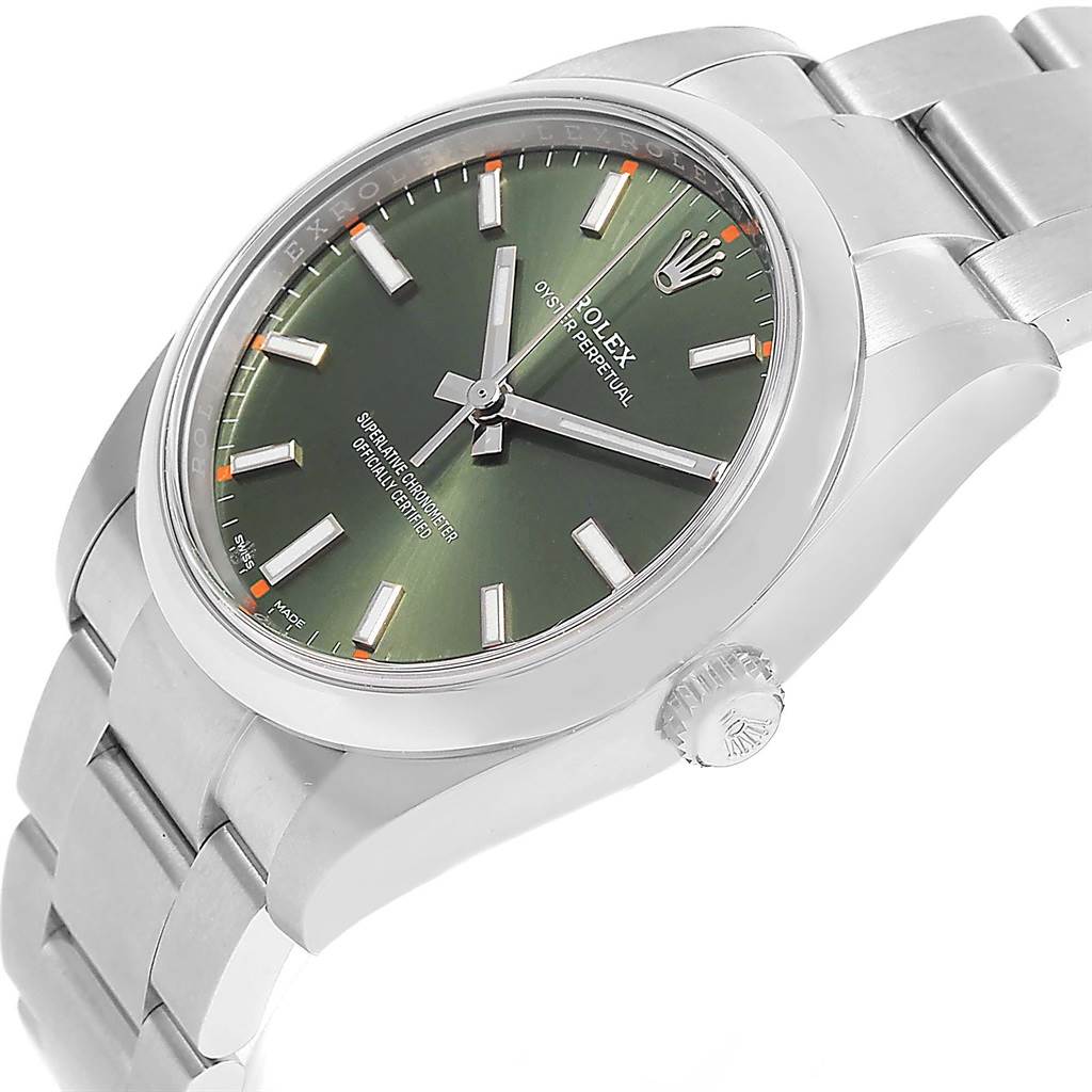 The image shows an angled view of the Rolex Oyster Perpetual 114200 Stainless Steel Green Dial 114200 Stainless Steel Green Dial watch, featuring the dial, crown, and bracelet.