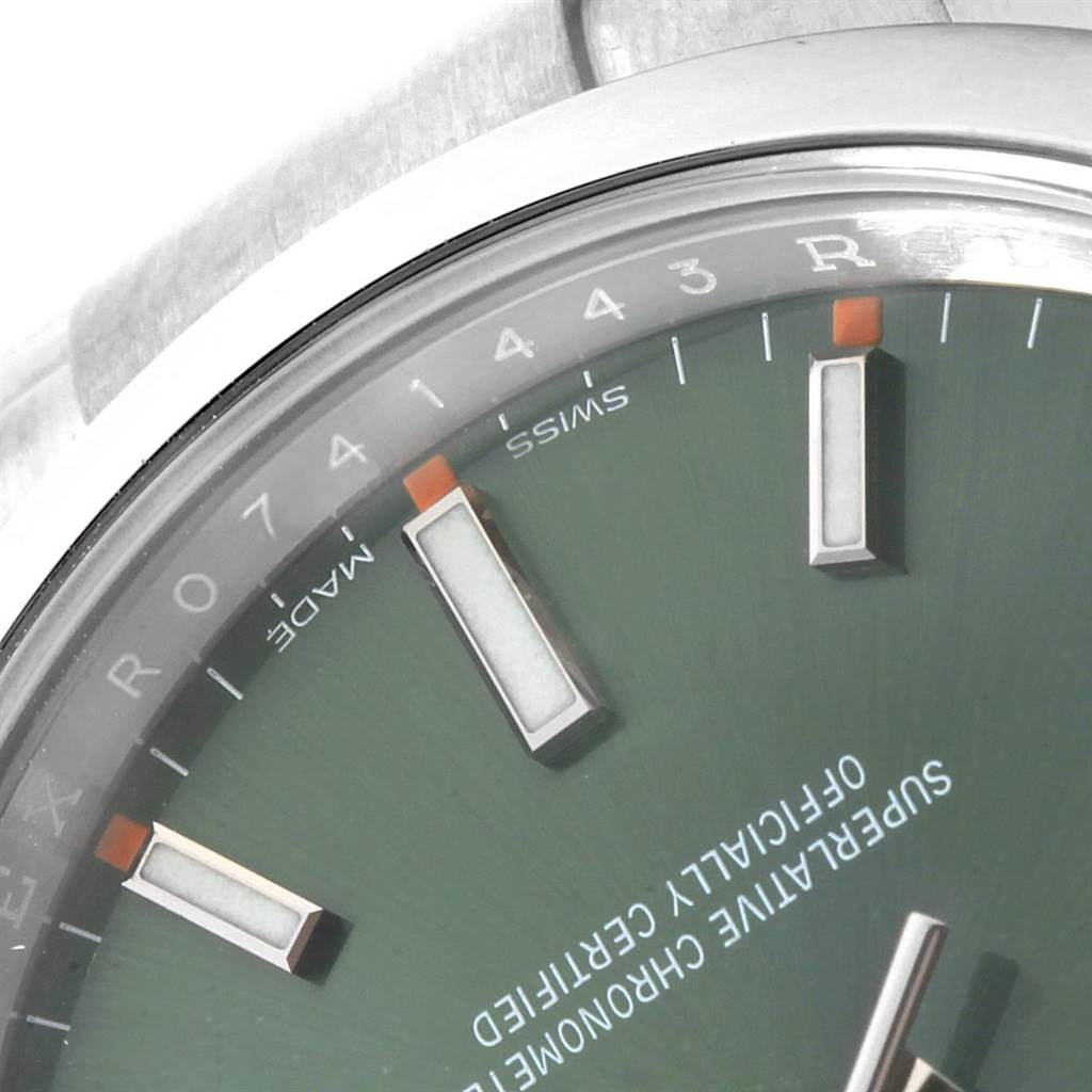 The image shows a close-up of the dial and bezel of the Rolex Oyster Perpetual 114200 Stainless Steel Green Dial 114200 Stainless Steel Green Dial watch.