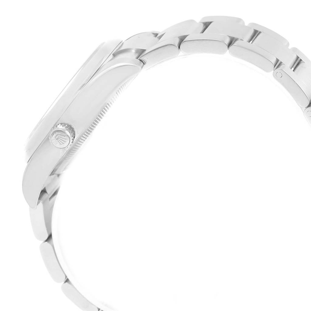 This image shows a side view of the Rolex Oyster Perpetual 114200 Men
s Stainless Steel Green Dial 114200 Men
s Stainless Steel Green Dial watch highlighting the case, bezel, crown, and part of the bracelet.