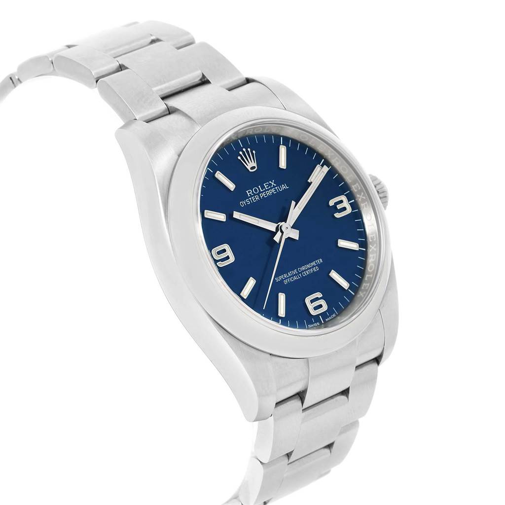 The image shows a Rolex Oyster Perpetual 116000 Men's Stainless Steel Blue Dial 116000 Men's Stainless Steel Blue Dial watch from an angled front view, highlighting its blue dial and stainless steel bracelet.