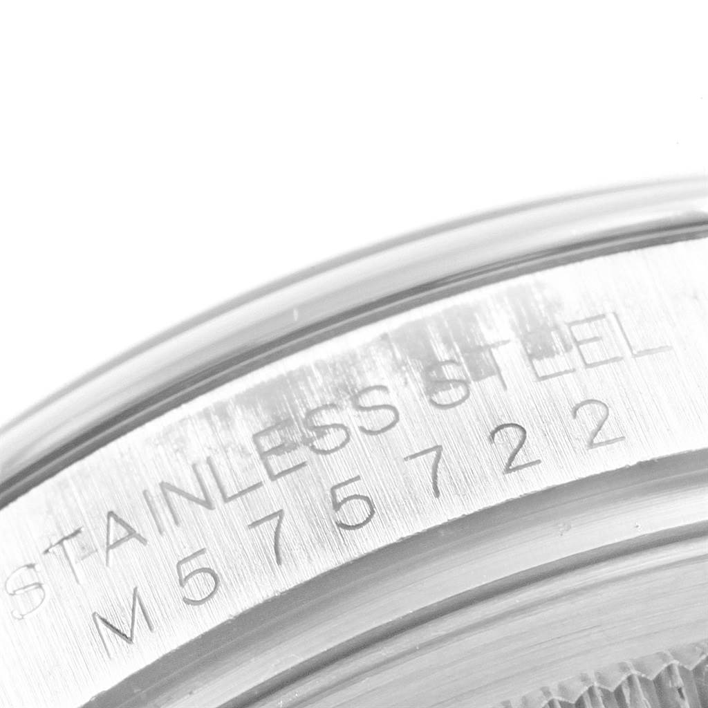 This is a close-up of the case back of a Rolex Oyster Perpetual 116000 Men's Stainless Steel Blue Dial 116000 Men's Stainless Steel Blue Dial watch, showing the serial number engraving.