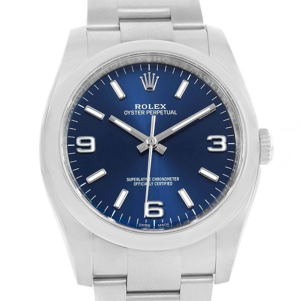 The image shows a front view of a Rolex Oyster Perpetual 116000 Men's Stainless Steel Blue Dial 116000 Men's Stainless Steel Blue Dial watch with a blue dial and silver bracelet.