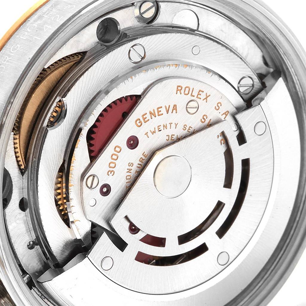 This image shows a close-up of the movement mechanism inside a Rolex Oyster Perpetual 14233 Men's Steel and Gold (two tone) Champagne Dial 14233 Men's Steel and Gold (two tone) Champagne Dial watch, focusing on gears and inscriptions.