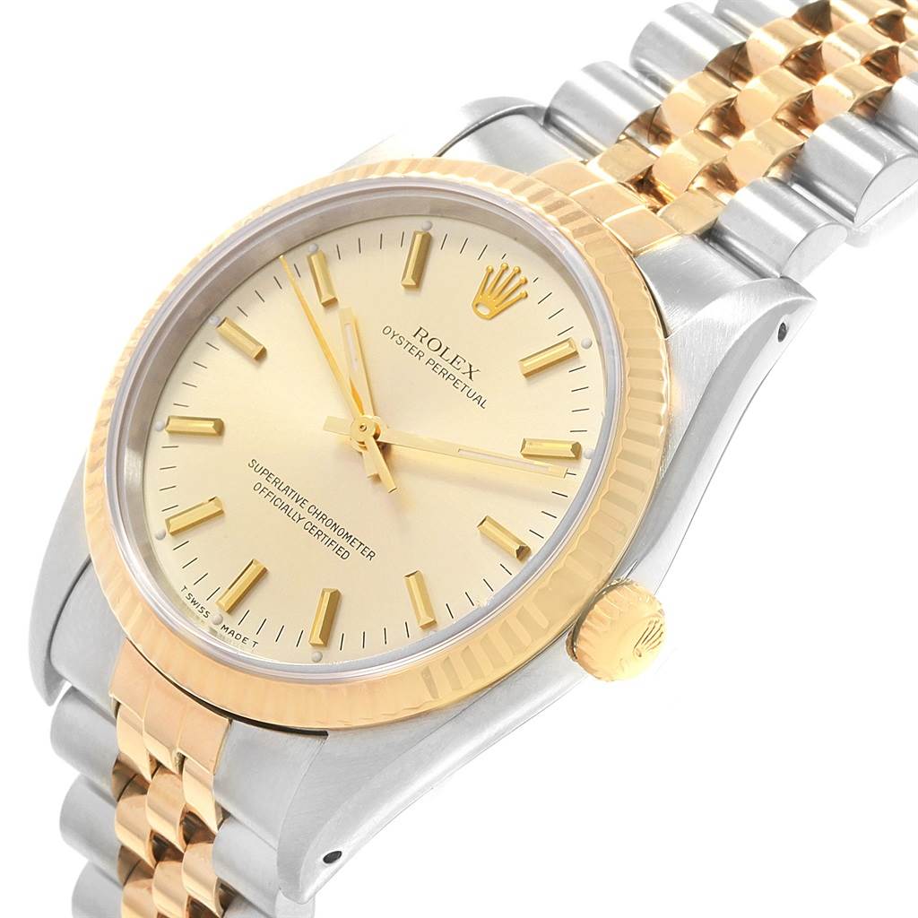The image shows a close-up, angled view of a Rolex Oyster Perpetual 14233 Men's Steel and Gold (two tone) Champagne Dial 14233 Men's Steel and Gold (two tone) Champagne Dial watch, highlighting its dial, bezel, and part of the bracelet.