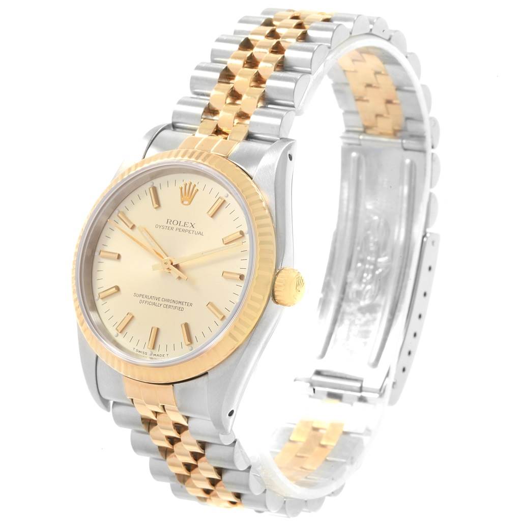 The image shows a Rolex Oyster Perpetual 14233 Men's Steel and Gold (two tone) Champagne Dial 14233 Men's Steel and Gold (two tone) Champagne Dial watch at an angled view, highlighting the gold and silver strap and cream dial.