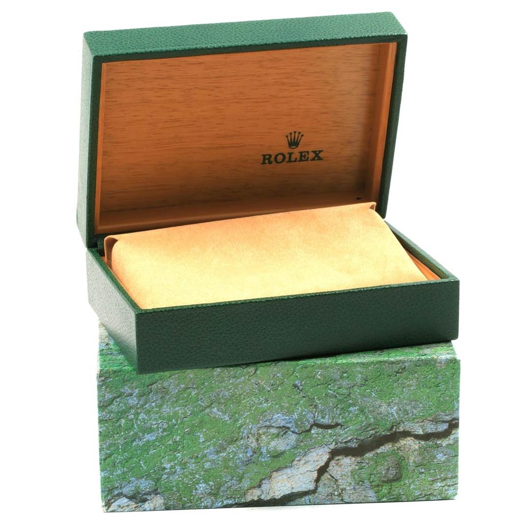 The image shows an open Rolex box for the Oyster Perpetual model, with the inner cushion and branded interior visible.