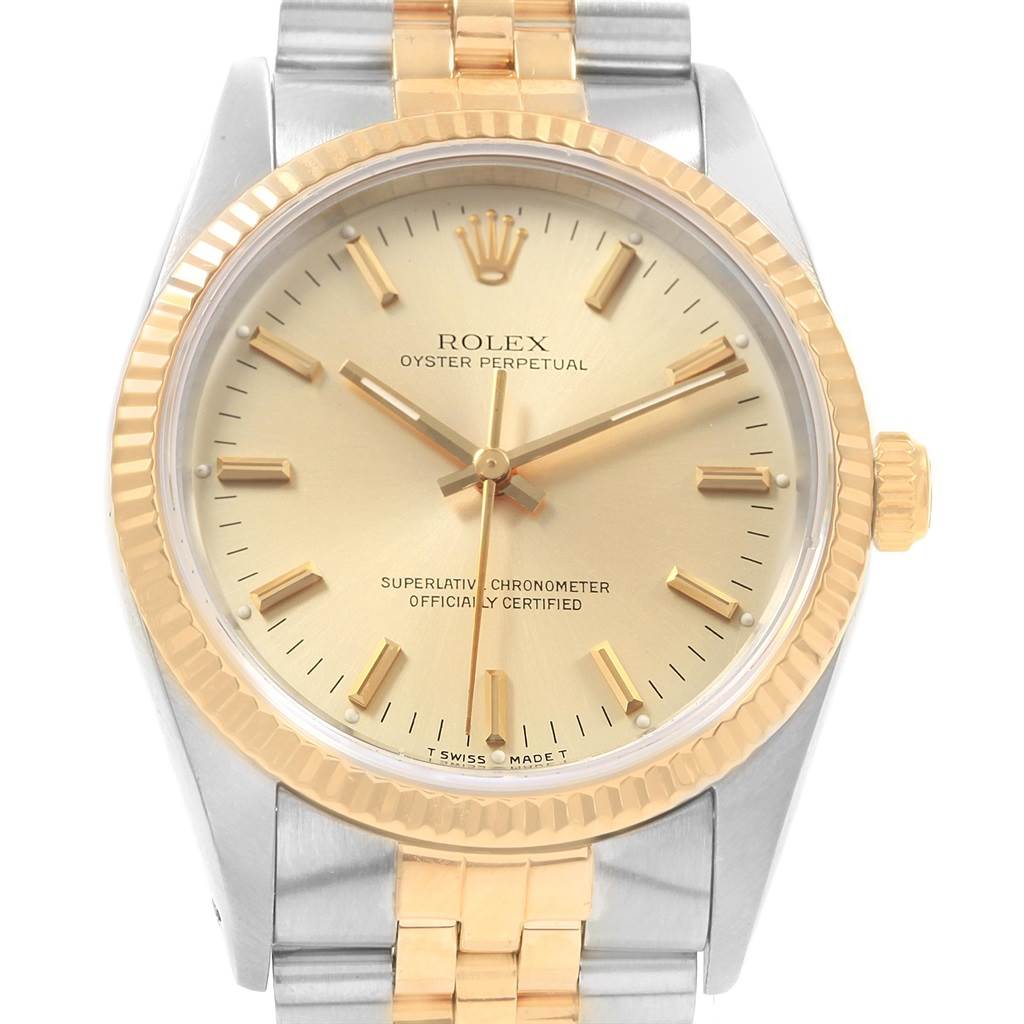 This is a front view of a Rolex Oyster Perpetual 14233 Men's Steel and Gold (two tone) Champagne Dial 14233 Men's Steel and Gold (two tone) Champagne Dial watch, showcasing the two-tone bezel, dial, and bracelet.