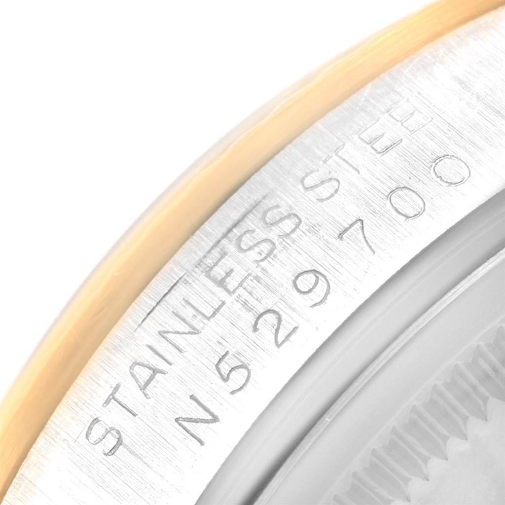 This image shows a close-up of the bezel and case of the Rolex Oyster Perpetual 14233 Men's Steel and Gold (two tone) Champagne Dial 14233 Men's Steel and Gold (two tone) Champagne Dial, highlighting the stainless steel engraving.