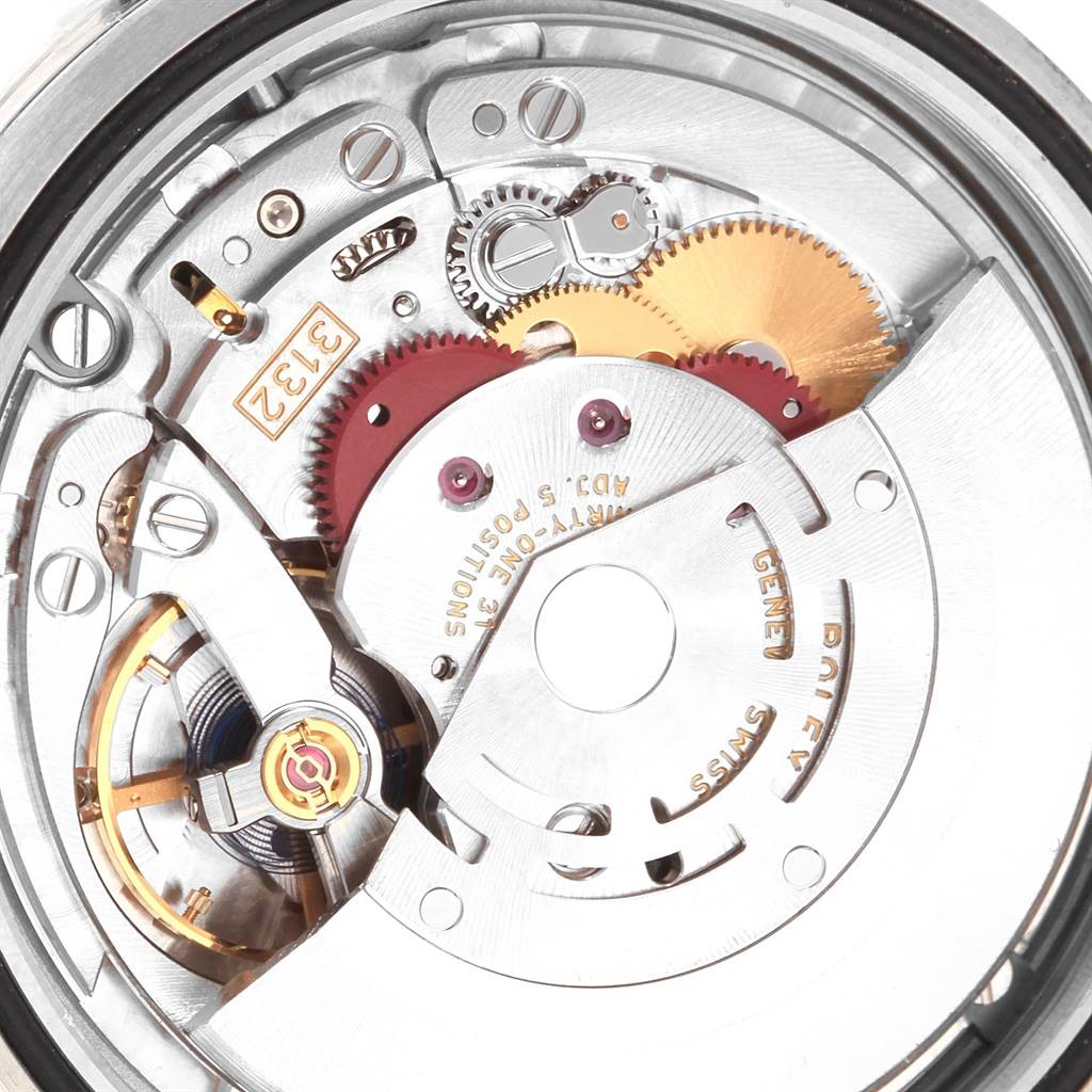 This close-up image shows the intricate internal mechanism and gears of a Rolex Oyster Perpetual 114300 Men
s Stainless Steel Blue Dial 114300 Men
s Stainless Steel Blue Dial watch.