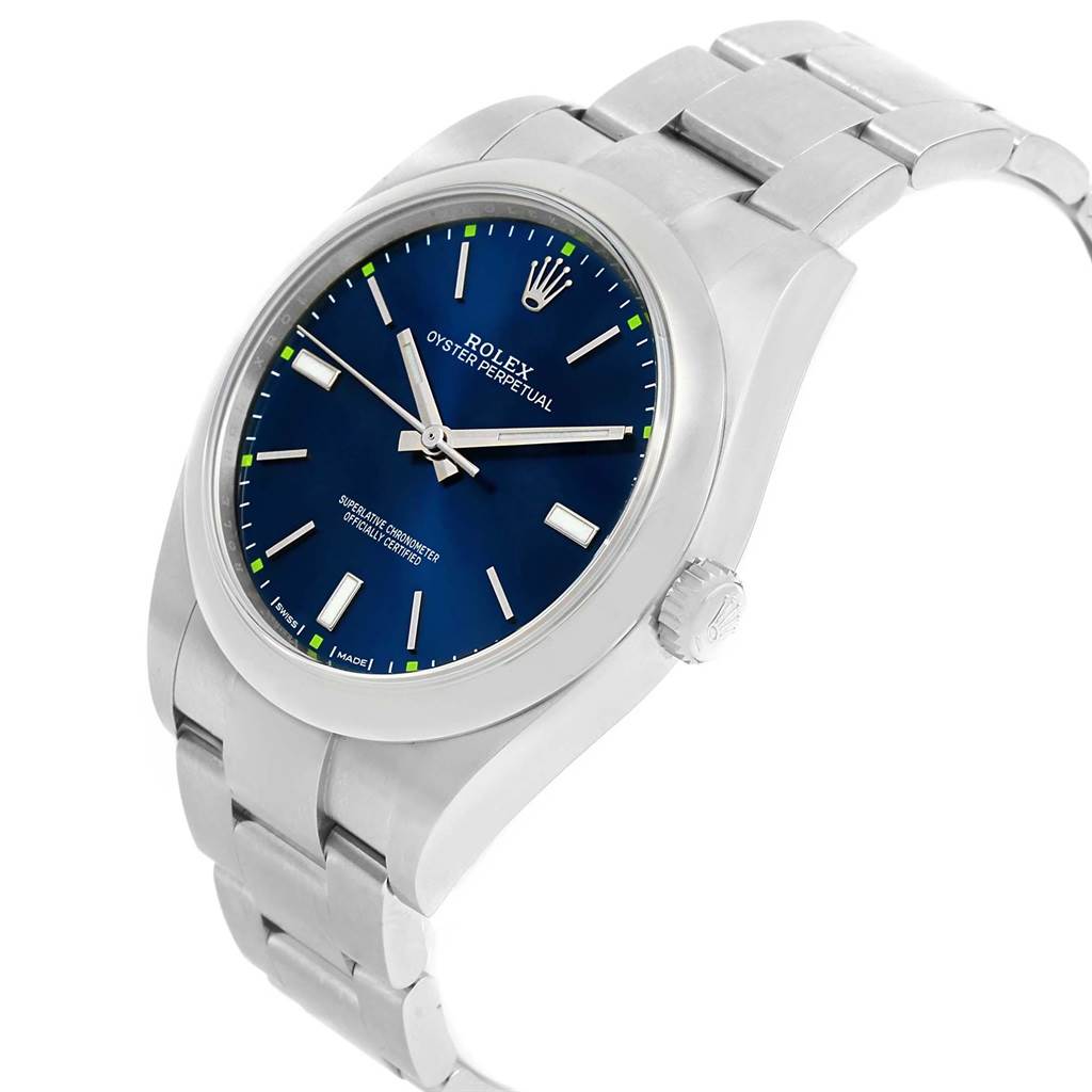 The image shows a Rolex Oyster Perpetual 114300 Men
s Stainless Steel Blue Dial 114300 Men
s Stainless Steel Blue Dial watch from a side angle, highlighting the dial, case, crown, and bracelet.