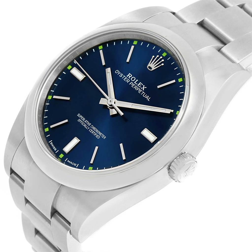 The image shows a Rolex Oyster Perpetual 114300 Men
s Stainless Steel Blue Dial 114300 Men
s Stainless Steel Blue Dial watch at a 3/4 angle, highlighting the face, bezel, crown, and part of the bracelet.