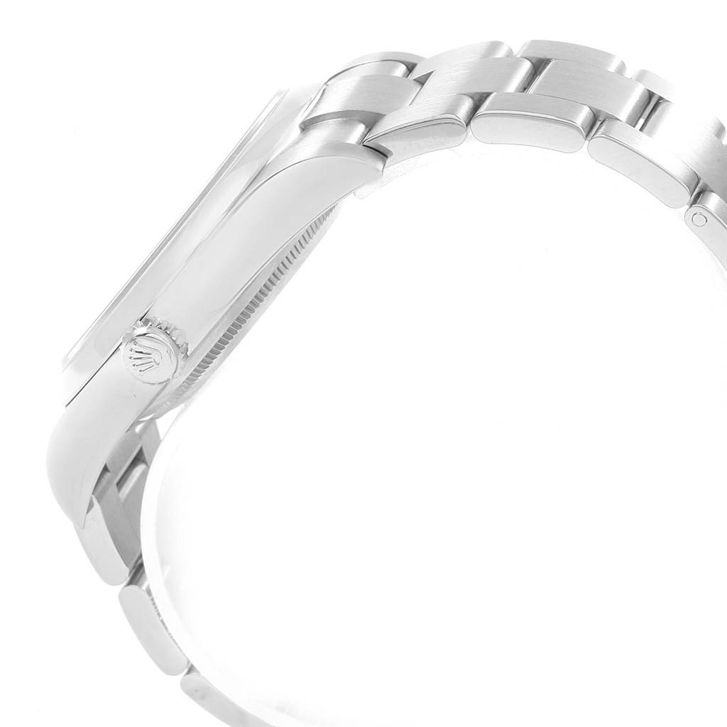 The image shows a side view of a Rolex Oyster Perpetual 114300 Men
s Stainless Steel Grey Dial 114300 Men
s Stainless Steel Grey Dial watch, highlighting the crown and part of the bracelet.