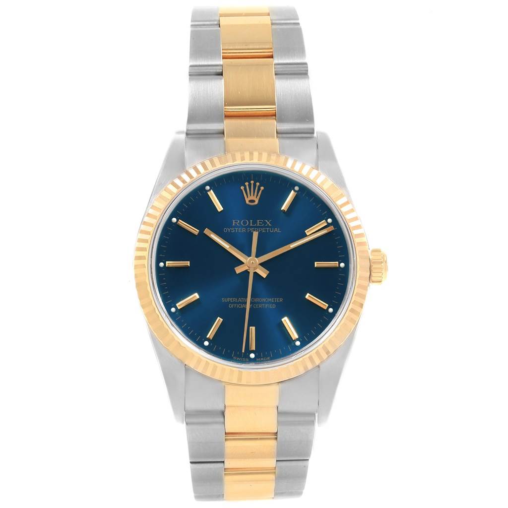 This Rolex Oyster Perpetual 14233 Men's Steel and Gold (two tone) Blue Dial 14233 Men's Steel and Gold (two tone) Blue Dial watch is shown from a front angle, highlighting its blue dial, gold bezel, and two-tone metal bracelet.
