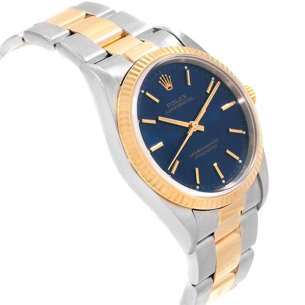 The Rolex Oyster Perpetual 14233 Men's Steel and Gold (two tone) Blue Dial 14233 Men's Steel and Gold (two tone) Blue Dial watch is shown at a slight angle, highlighting the blue dial, gold bezel, and two-tone bracelet.