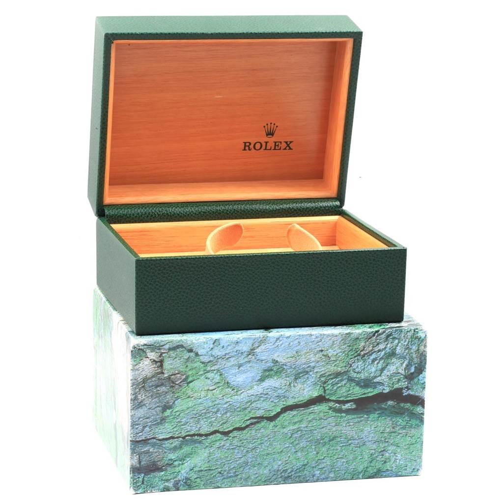 This image shows an open Rolex Oyster Perpetual 14233 Men's Steel and Gold (two tone) Blue Dial 14233 Men's Steel and Gold (two tone) Blue Dial watch box, revealing its green exterior and wood-lined interior.