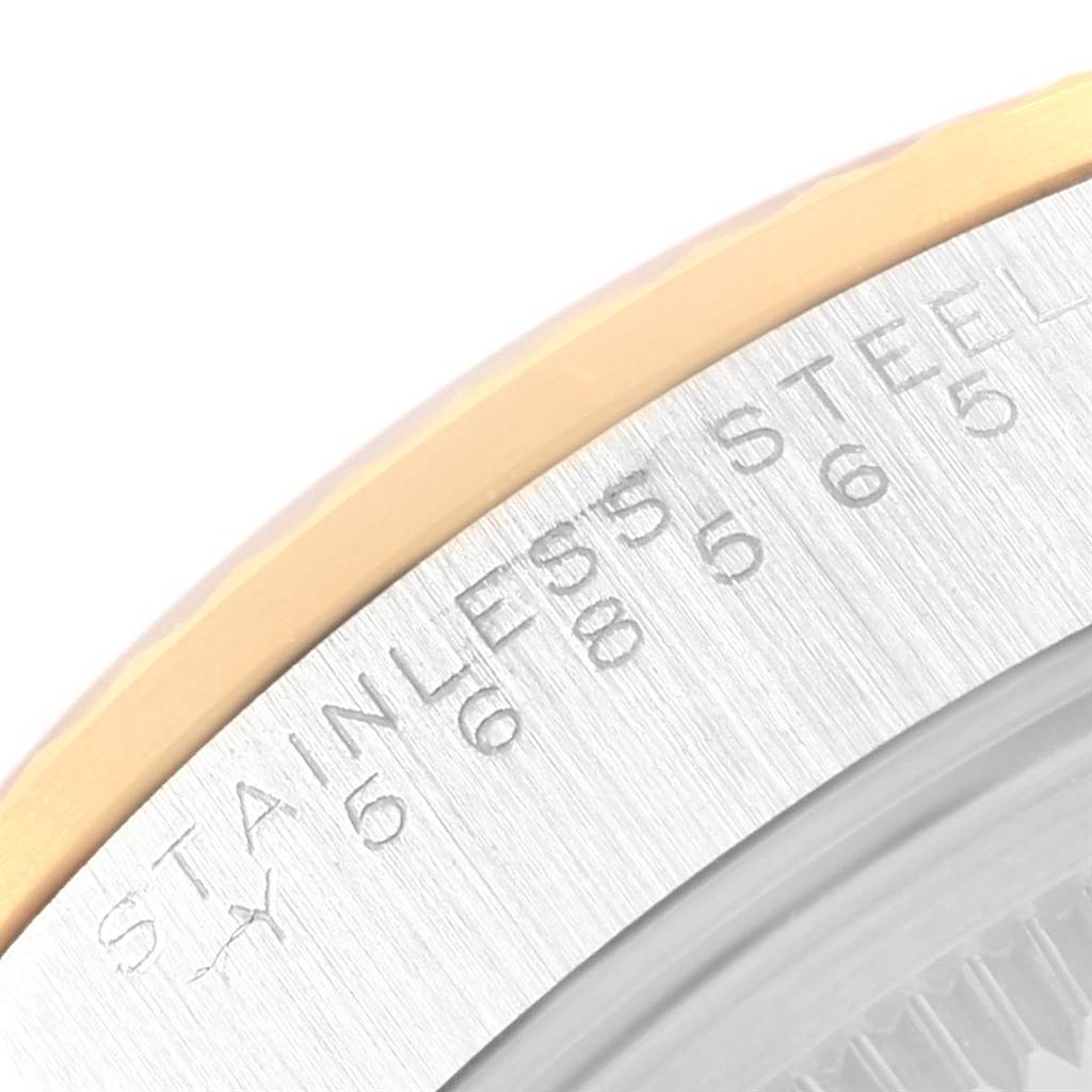 This close-up image of a Rolex Oyster Perpetual 14233 Men's Steel and Gold (two tone) Black Dial 14233 Men's Steel and Gold (two tone) Black Dial watch shows the edge of the case back with "STAINLESS STEEL" engraved.