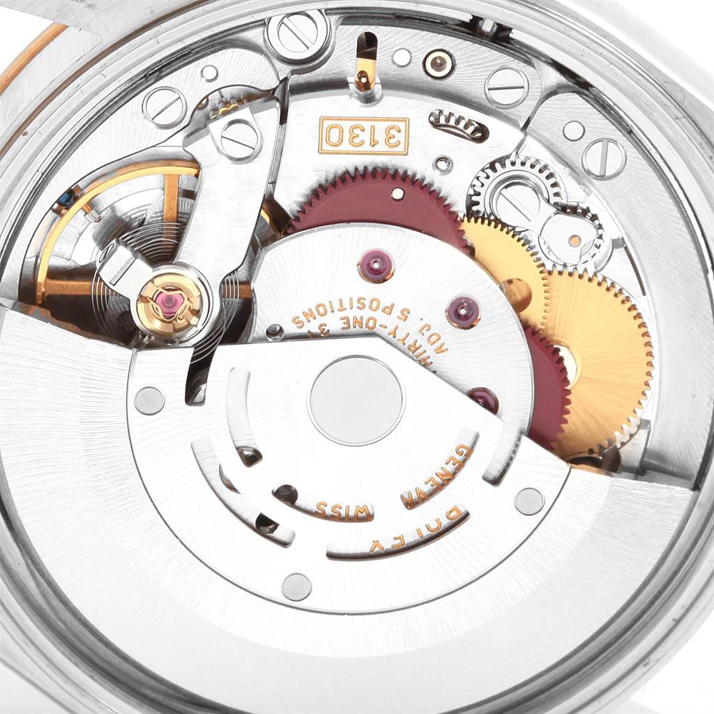 This image shows an underside view of the movement mechanism inside an Oyster Perpetual Rolex watch.