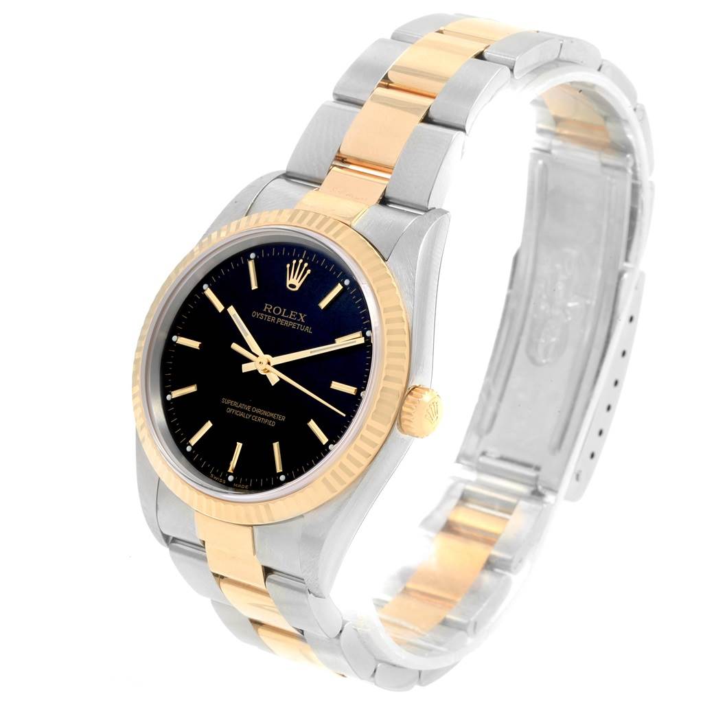 The Rolex Oyster Perpetual 14233 Men's Steel and Gold (two tone) Black Dial 14233 Men's Steel and Gold (two tone) Black Dial model is shown at a slight angle, highlighting its two-tone band, black dial, and gold bezel.