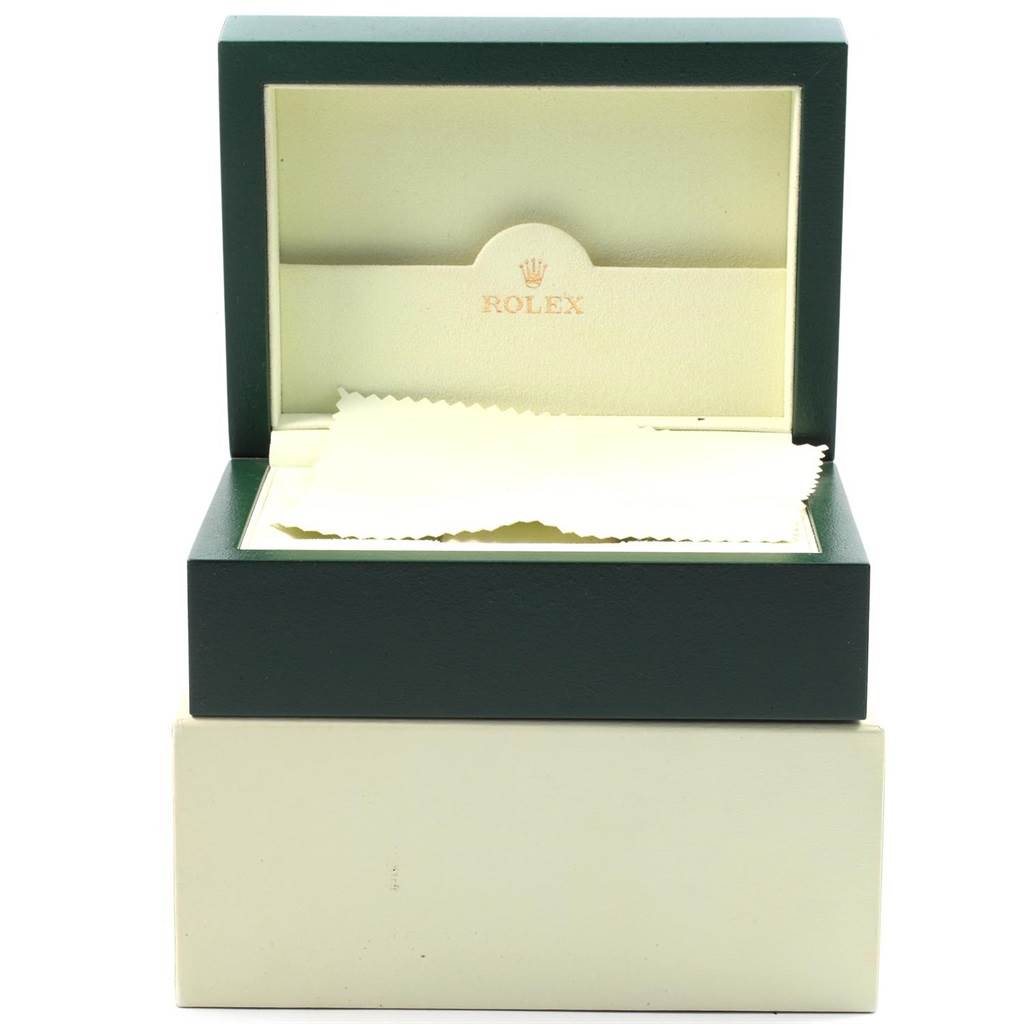 The image shows an open Rolex box for an Oyster Perpetual model, displaying the interior and a cleaning cloth.