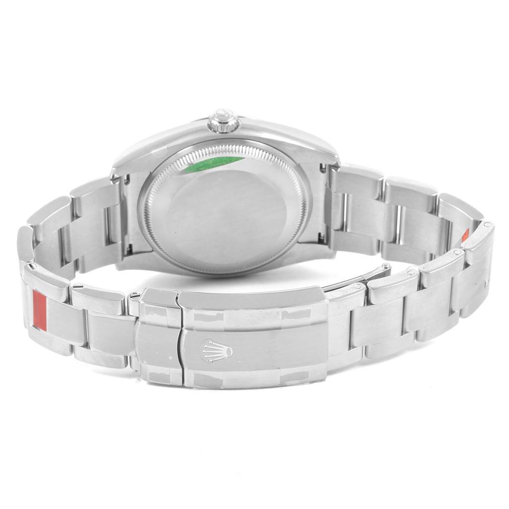 The image shows the back view of a Rolex Oyster Perpetual 114200 Men's Stainless Steel Black Dial 114200 Men's Stainless Steel Black Dial watch, highlighting the case back and bracelet clasp.