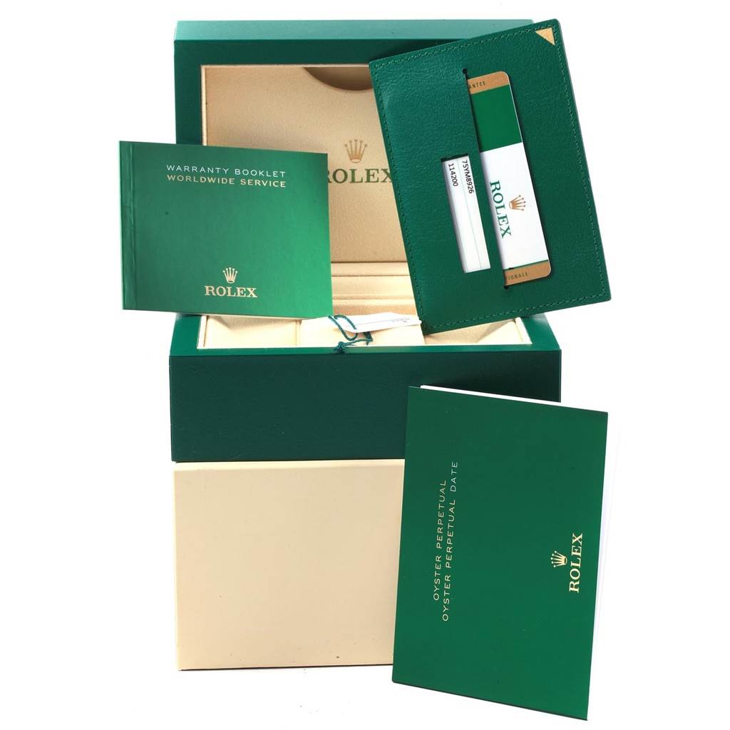 The image shows the packaging and accessories for a Rolex Oyster Perpetual 114200 Men's Stainless Steel Black Dial 114200 Men's Stainless Steel Black Dial, including booklets and a warranty card holder.