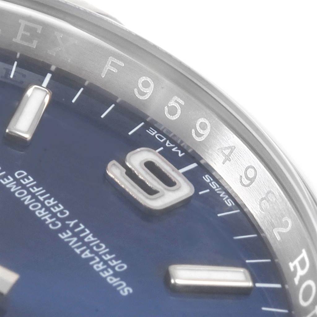 Close-up of a Rolex Oyster Perpetual 116000 Men
s Stainless Steel Blue Dial 116000 Men
s Stainless Steel Blue Dial watch showing part of the bezel, dial, and hour markers.