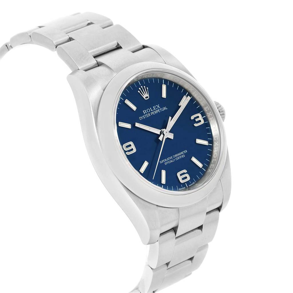 This image shows a front-side angle of the Rolex Oyster Perpetual 116000 Men
s Stainless Steel Blue Dial 116000 Men
s Stainless Steel Blue Dial watch, highlighting its blue dial, stainless steel case, and bracelet.