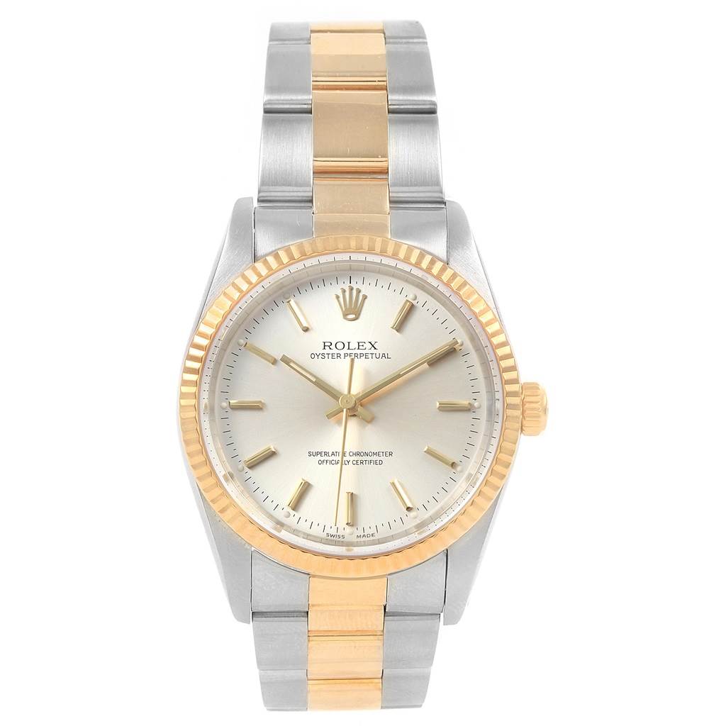 This image shows a Rolex Oyster Perpetual 14233 Men's Steel and Gold (two tone) Silver Dial 14233 Men's Steel and Gold (two tone) Silver Dial watch from the front, featuring a silver and gold design with a fluted bezel.