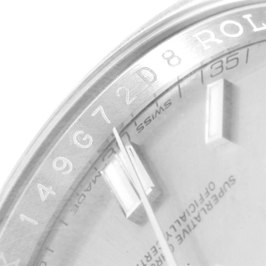 This image shows a partial view of the dial and bezel of a Rolex Oyster Perpetual 116000 Men
s Stainless Steel Grey Dial 116000 Men
s Stainless Steel Grey Dial watch.