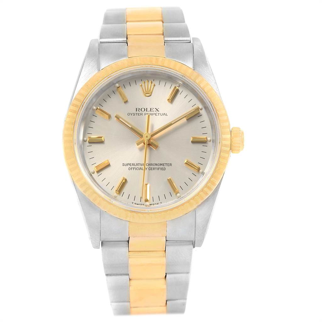 The Rolex Oyster Perpetual 14233 Men
s Steel and Gold (two tone) Silver Dial 14233 Men
s Steel and Gold (two tone) Silver Dial watch is shown from a front angle, displaying the face, bezel, and bracelet.