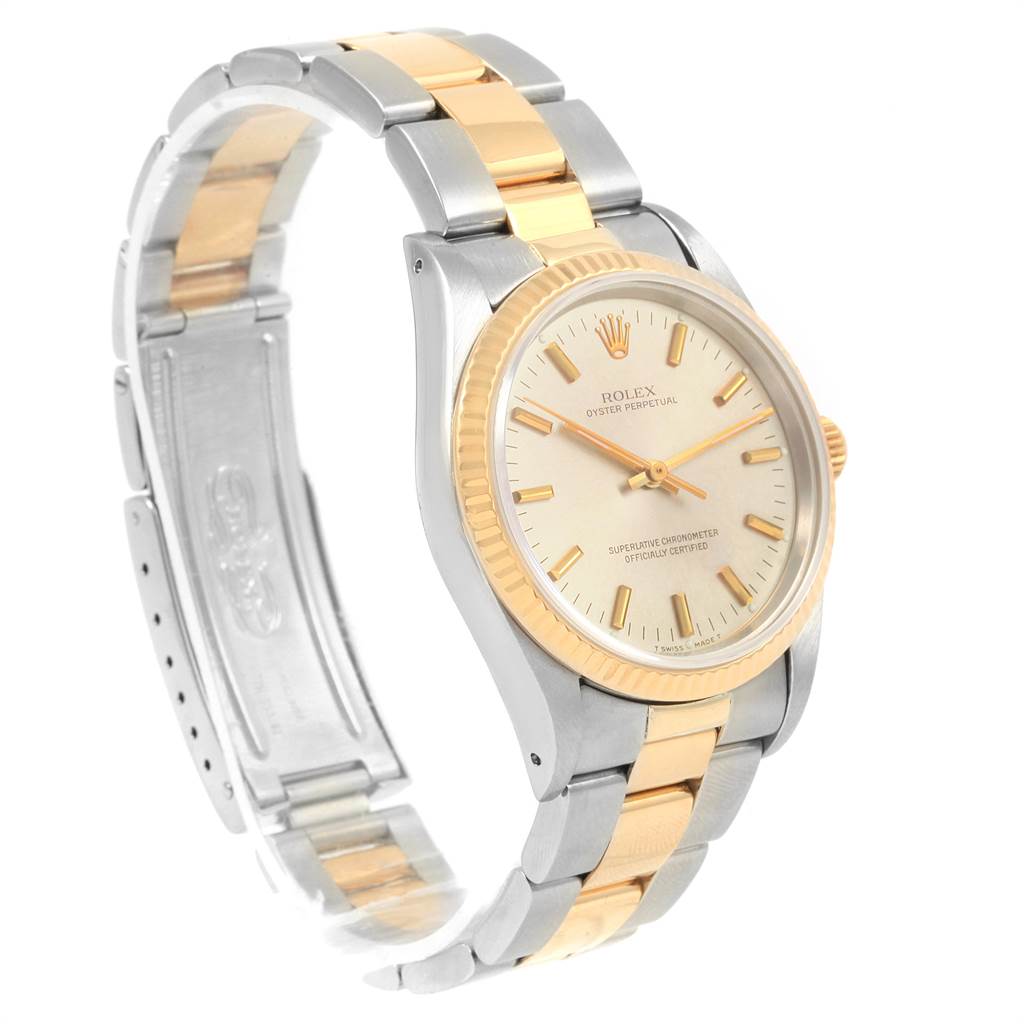 The Rolex Oyster Perpetual 14233 Men
s Steel and Gold (two tone) Silver Dial 14233 Men
s Steel and Gold (two tone) Silver Dial watch is shown at a side angle highlighting its two-tone bracelet, bezel, and dial.