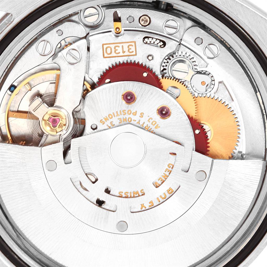 The image shows a close-up of the movement mechanism inside a Rolex Oyster Perpetual 116000 Men
s Stainless Steel Silver Dial 116000 Men
s Stainless Steel Silver Dial watch, viewed from the back.