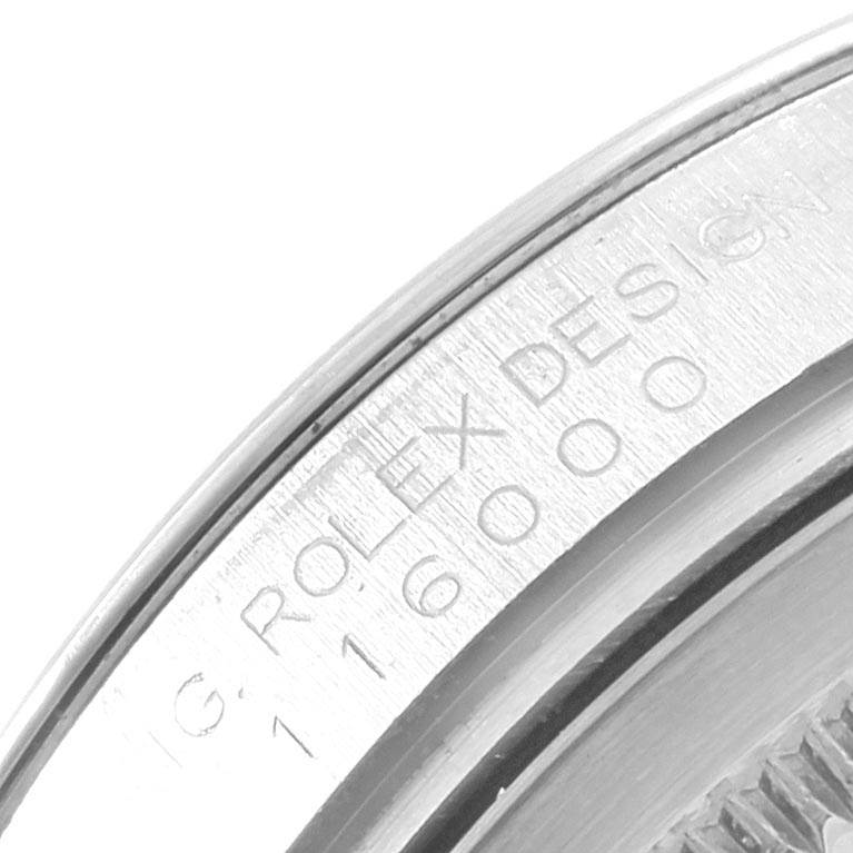 This close-up image shows the engraved bezel of a Rolex Oyster Perpetual 116000 Men
s Stainless Steel Silver Dial 116000 Men
s Stainless Steel Silver Dial watch.
