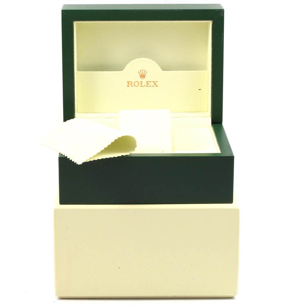 This image shows an open Rolex branded case for the Oyster Perpetual model, accompanied by a cleaning cloth.
